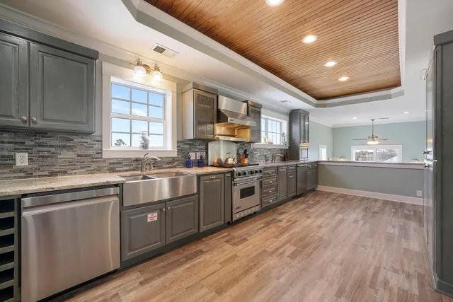 a kitchen with stainless steel appliances granite countertop a stove and a sink