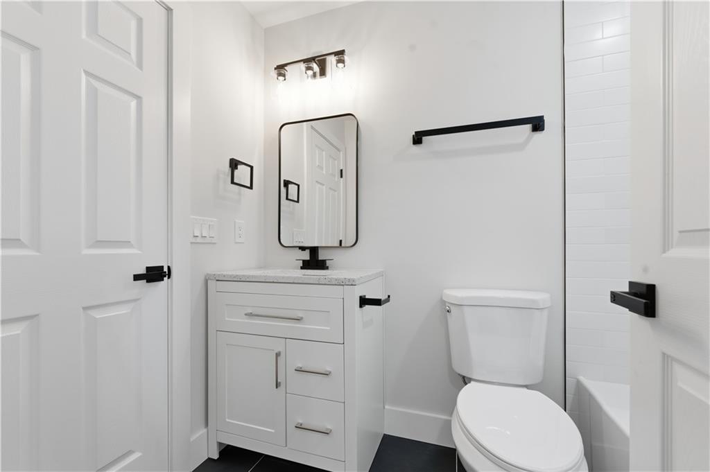 435 Lakepoint Trace Canton, GA 30114 - Photo 29 of 80 a bathroom with a toilet sink and mirror