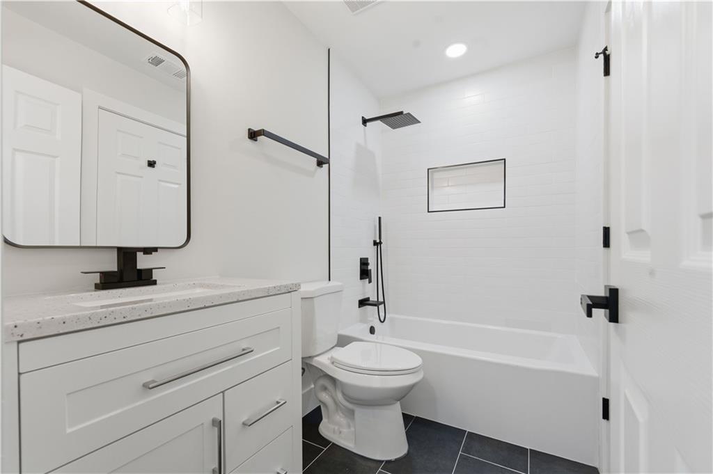 435 Lakepoint Trace Canton, GA 30114 - Photo 30 of 80 a bathroom with a granite countertop sink a toilet and shower