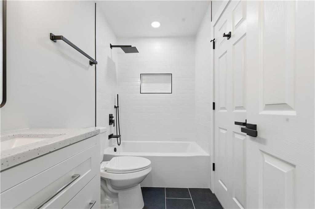 435 Lakepoint Trace Canton, GA 30114 - Photo 31 of 80 a bathroom with a sink a toilet and shower