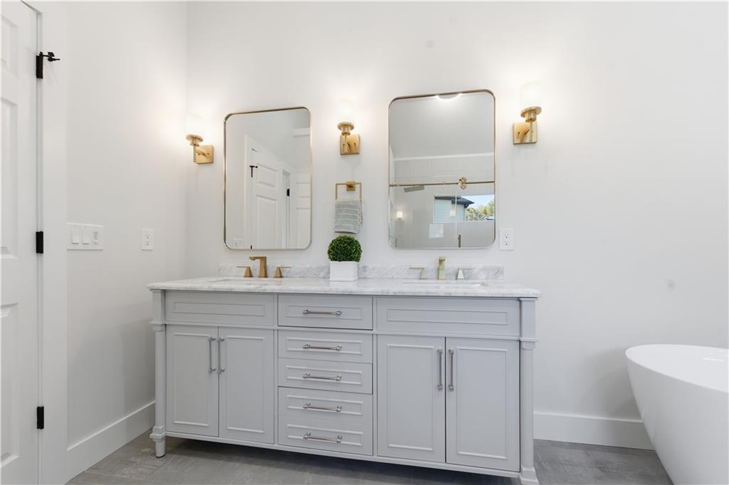 435 Lakepoint Trace Canton, GA 30114 - Photo 45 of 80 a bathroom with a double vanity sink and a mirror