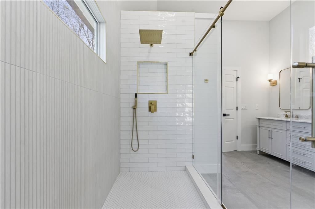 435 Lakepoint Trace Canton, GA 30114 - Photo 49 of 80 a bathroom with a granite countertop sink a toilet and shower