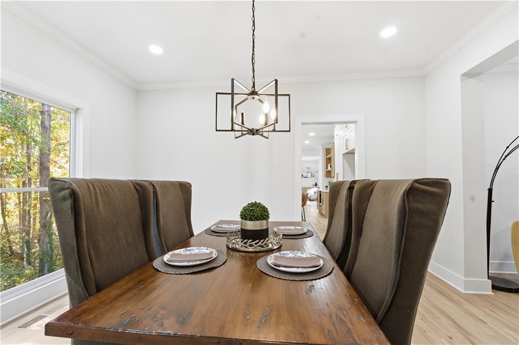 435 Lakepoint Trace Canton, GA 30114 - Photo 8 of 80 a view of a dining room with furniture a chandelier and wooden floor