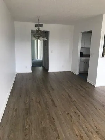 a view of a kitchen with a sink and dishwasher wooden floor