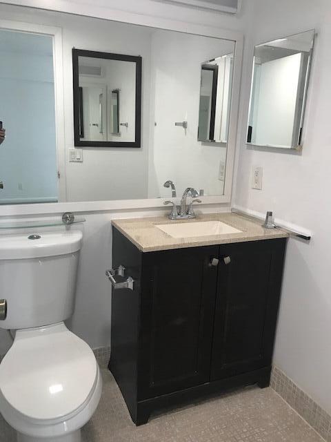 324 Mansfield H Boca Raton, FL 33434 - Photo 9 of 10 a bathroom with a toilet sink and mirror