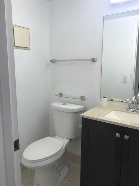 324 Mansfield H Boca Raton, FL 33434 - Photo 10 of 10 a bathroom with a toilet sink and mirror