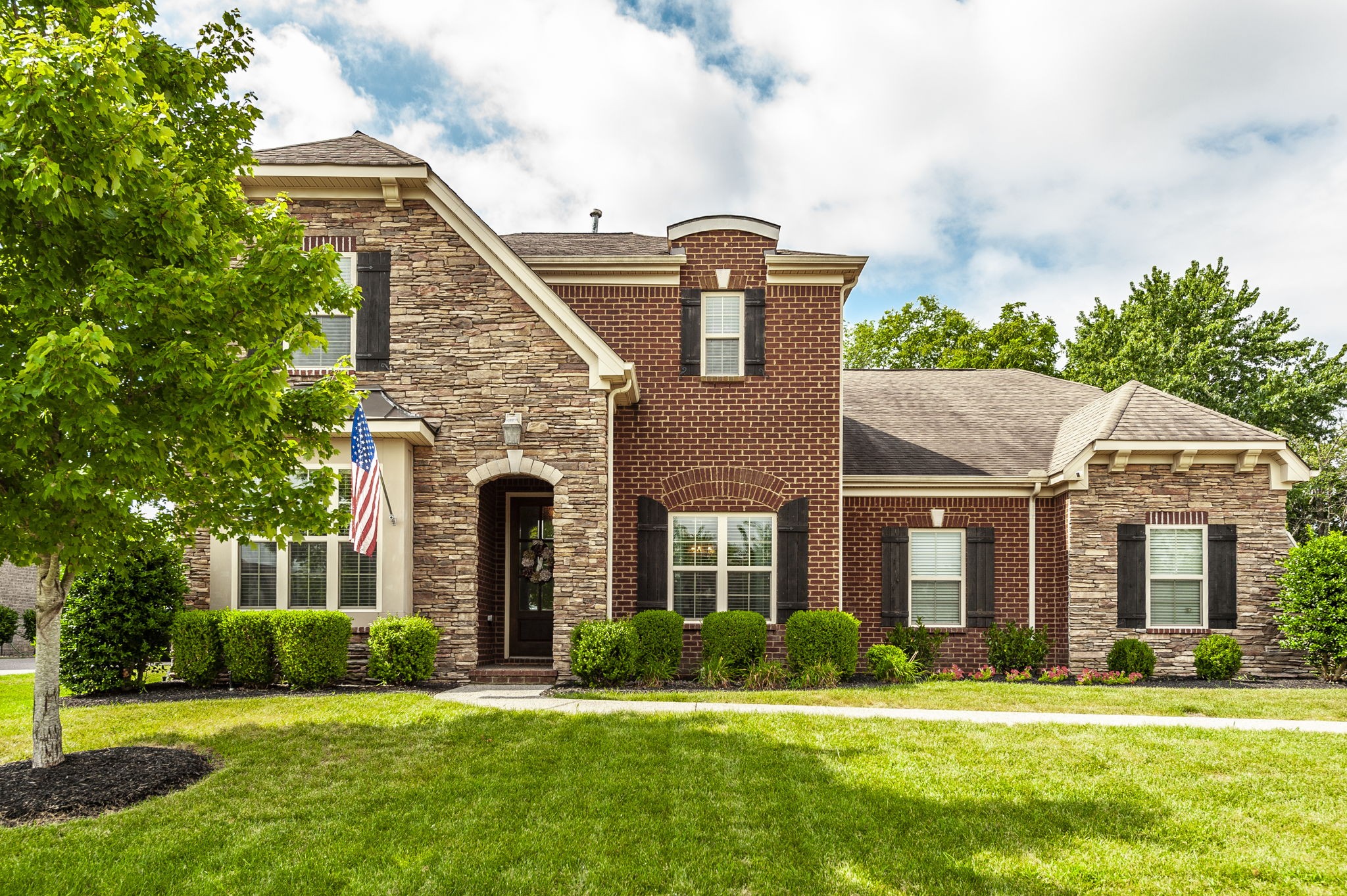 a front view of a house with a yard and garage