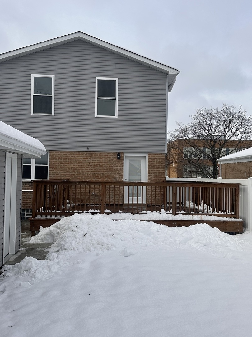 8017 South Kostner Avenue Chicago, IL 60652 - Photo 15 of 17 a view of house with yard and snow in the background