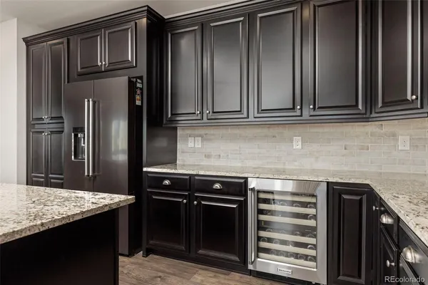 a kitchen with granite countertop a stove and a refrigerator