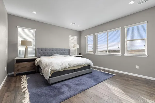 a bedroom with a bed and a large window