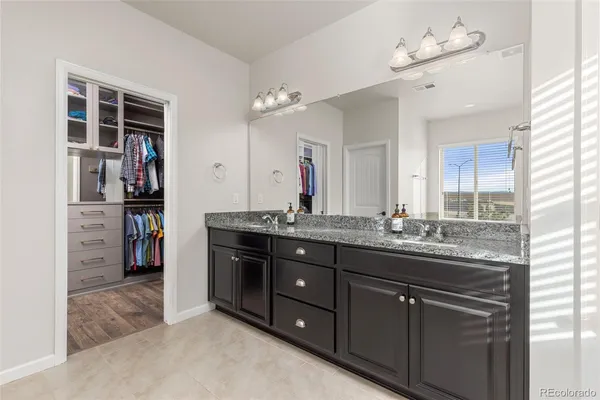 a bathroom with a tub shower and sink