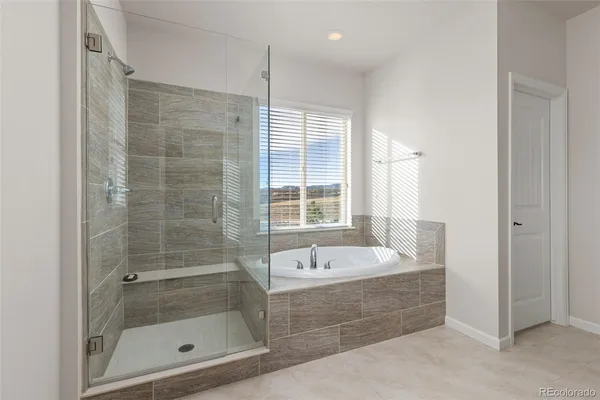 a bathroom with a tub shower and sink