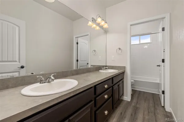 a bathroom with a granite countertop sink a large mirror and a