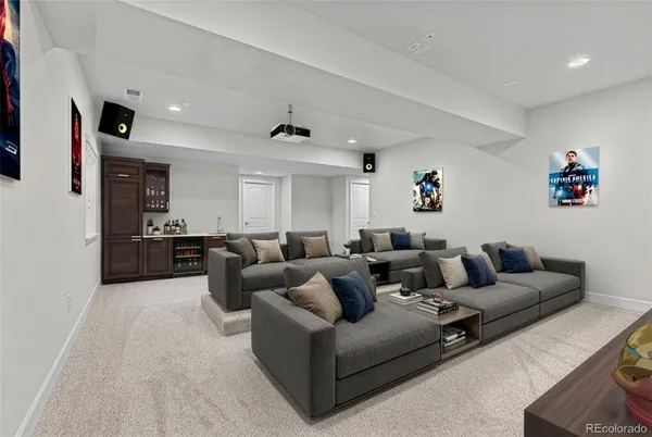 a living room with furniture and a view of kitchen