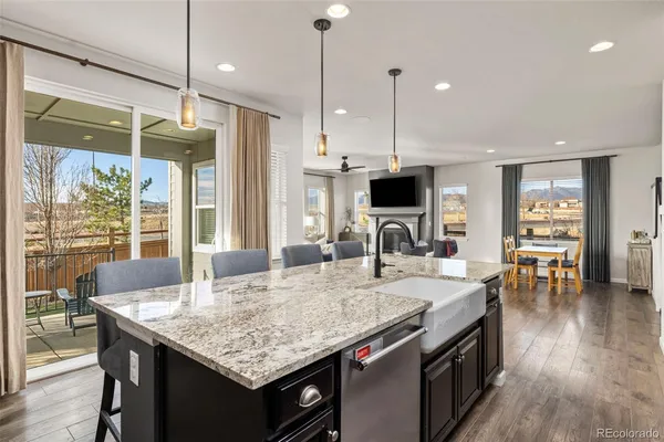 a kitchen with granite countertop kitchen island a table and chairs in it