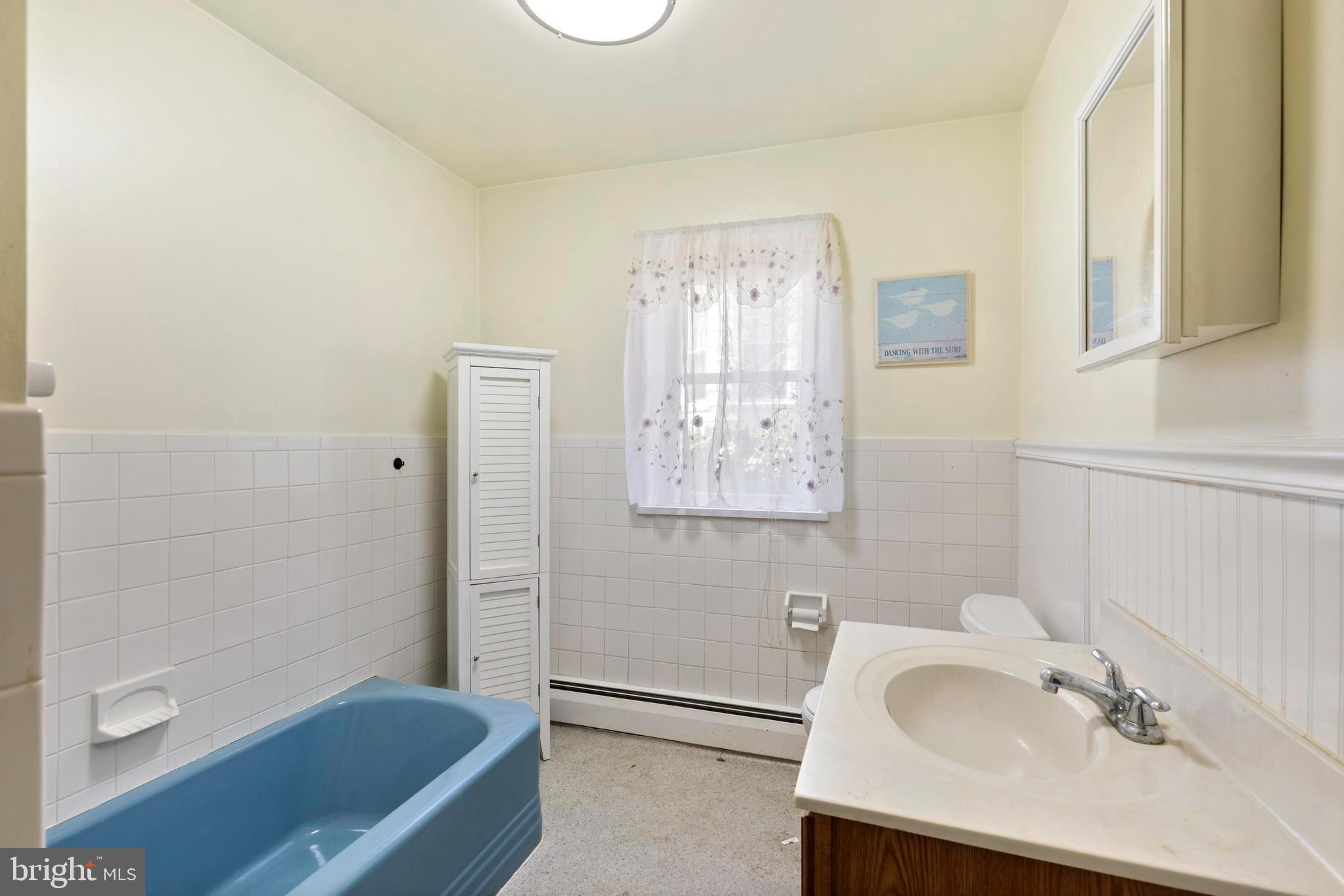1001 Primos Avenue Secane, PA 19018 - Photo 16 of 27 a bathroom with a sink a bathtub and a mirror