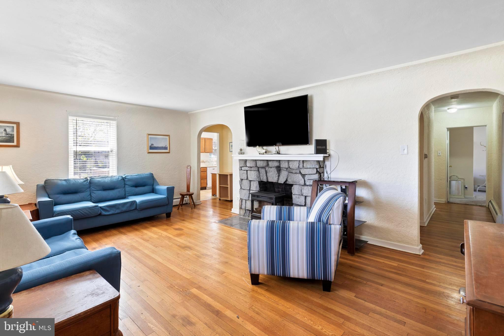 1001 Primos Avenue Secane, PA 19018 - Photo 4 of 27 a living room with furniture a fireplace and a flat screen tv