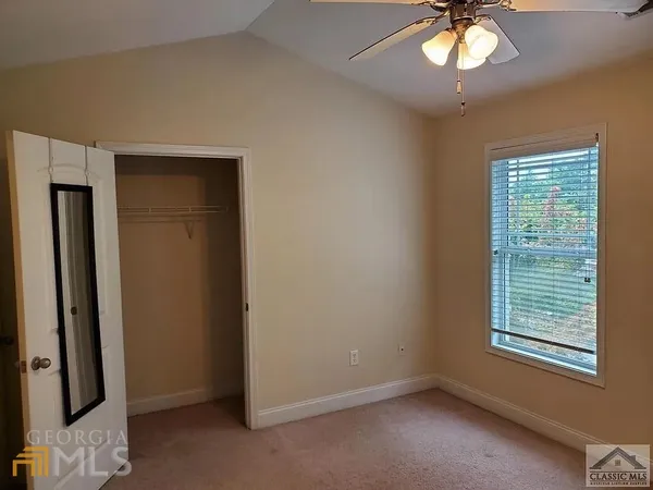 a kitchen with granite countertop a sink cabinets and wooden floor