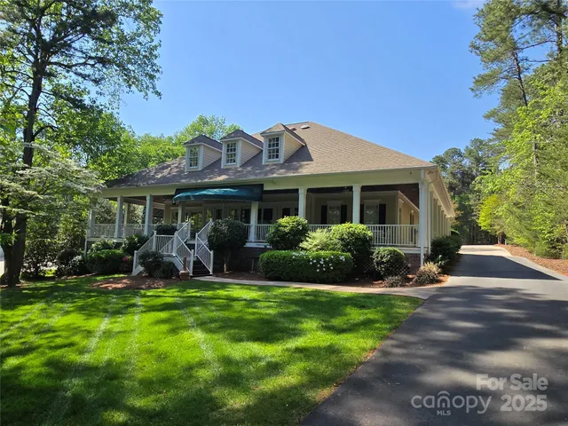 a front view of a house with yard and green space