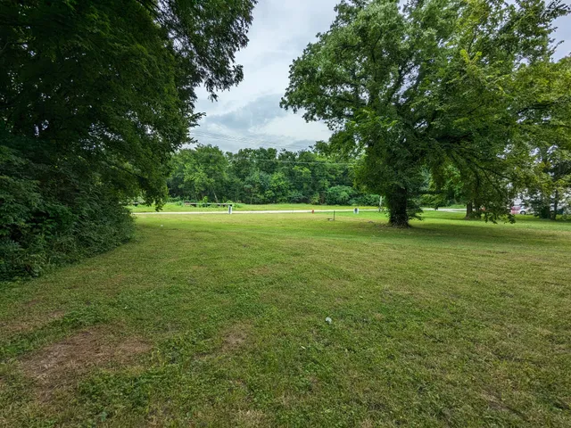a view of field with trees in the background