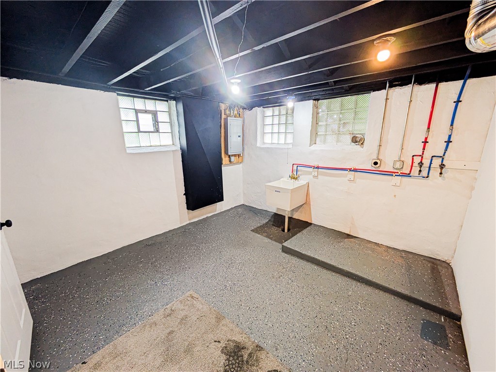 3554 Ludgate Road Shaker Heights, OH 44120 - Photo 48 of 50 Laundry area in the lower level w/ finished concrete flooring, exposed ceiling joists, utility sink, and glass block windows