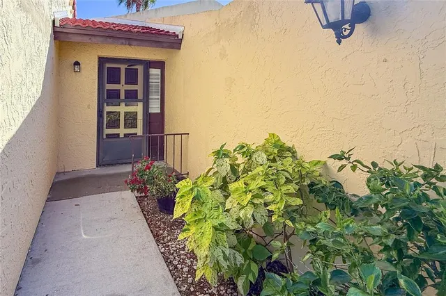 a view of a house with a potted plant and a window