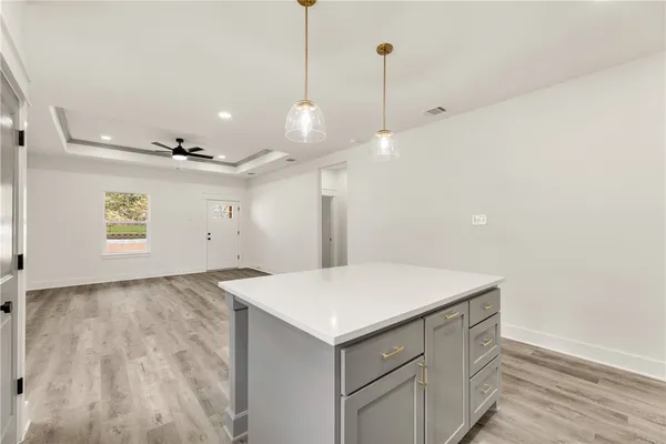 a room with a stove and a ceiling fan