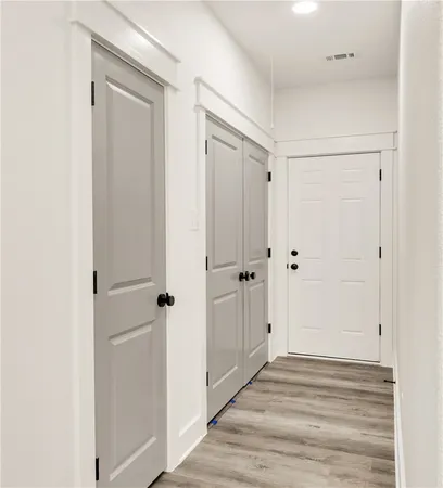 a view of a hallway with wooden floor