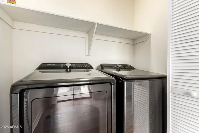 a view of storage and utility room with washer and dryer