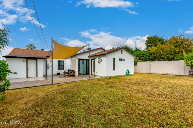a view of a house with a backyard and a garage