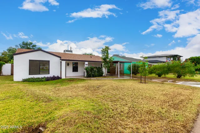 a front view of a house with a garden