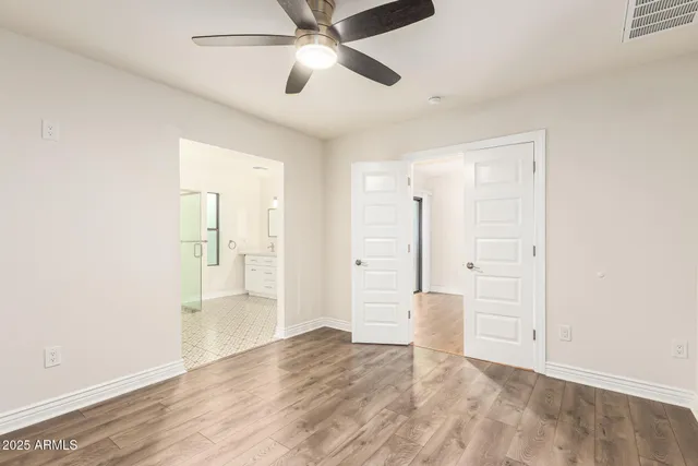 a view of empty room with wooden floor