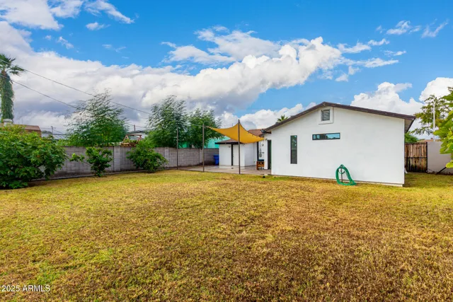 a view of a house with a yard and garage