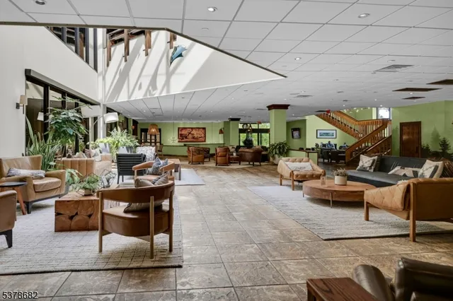 a living room with lots of furniture and a large window