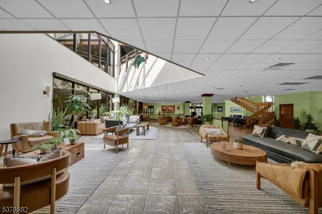 a living room with lots of furniture and clutter