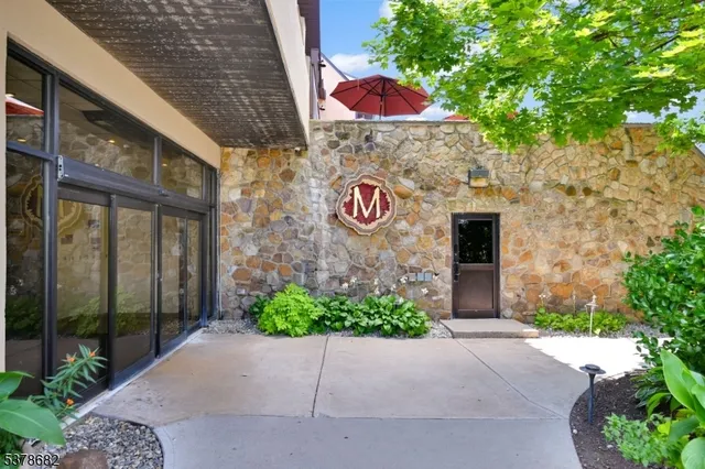 an aerial view of a swimming pool patio and outdoor seating