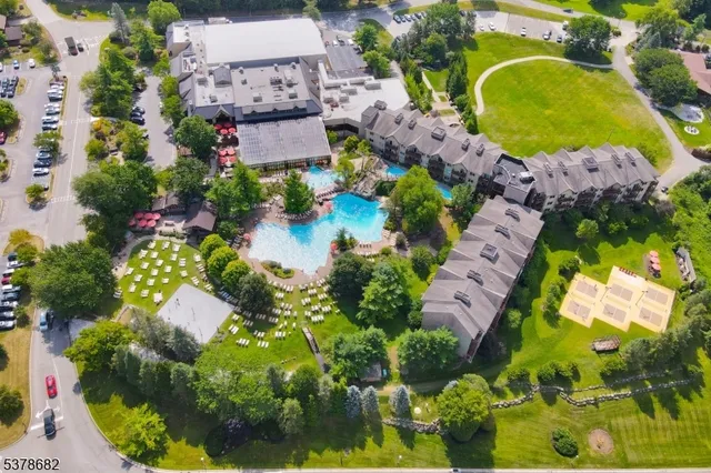 an aerial view of a house with swimming pool and outdoor space