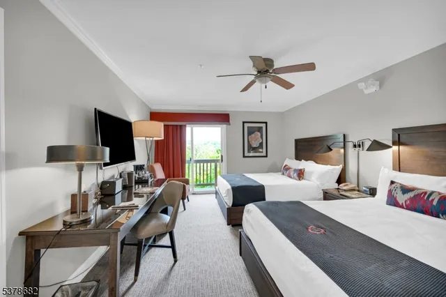 a living room with furniture flat screen tv and a large window