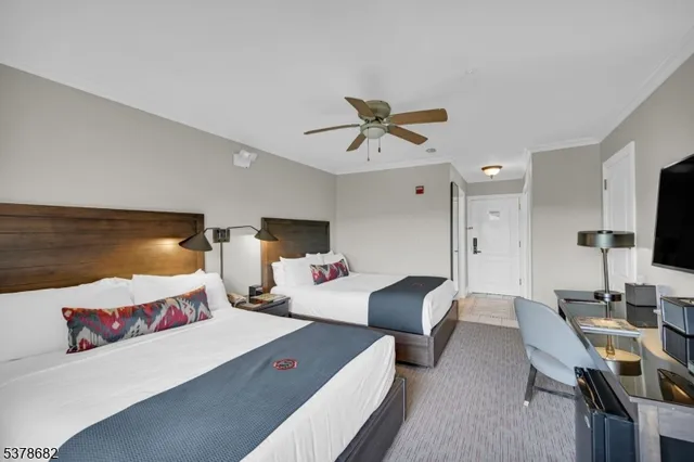 a bedroom with a bed a desk and chair