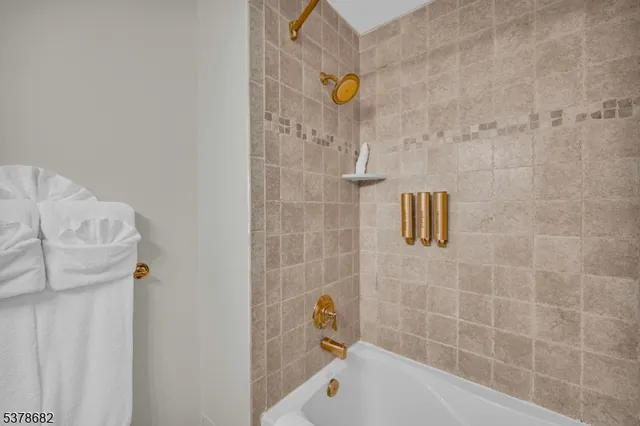 a bathroom with a tub and a shower