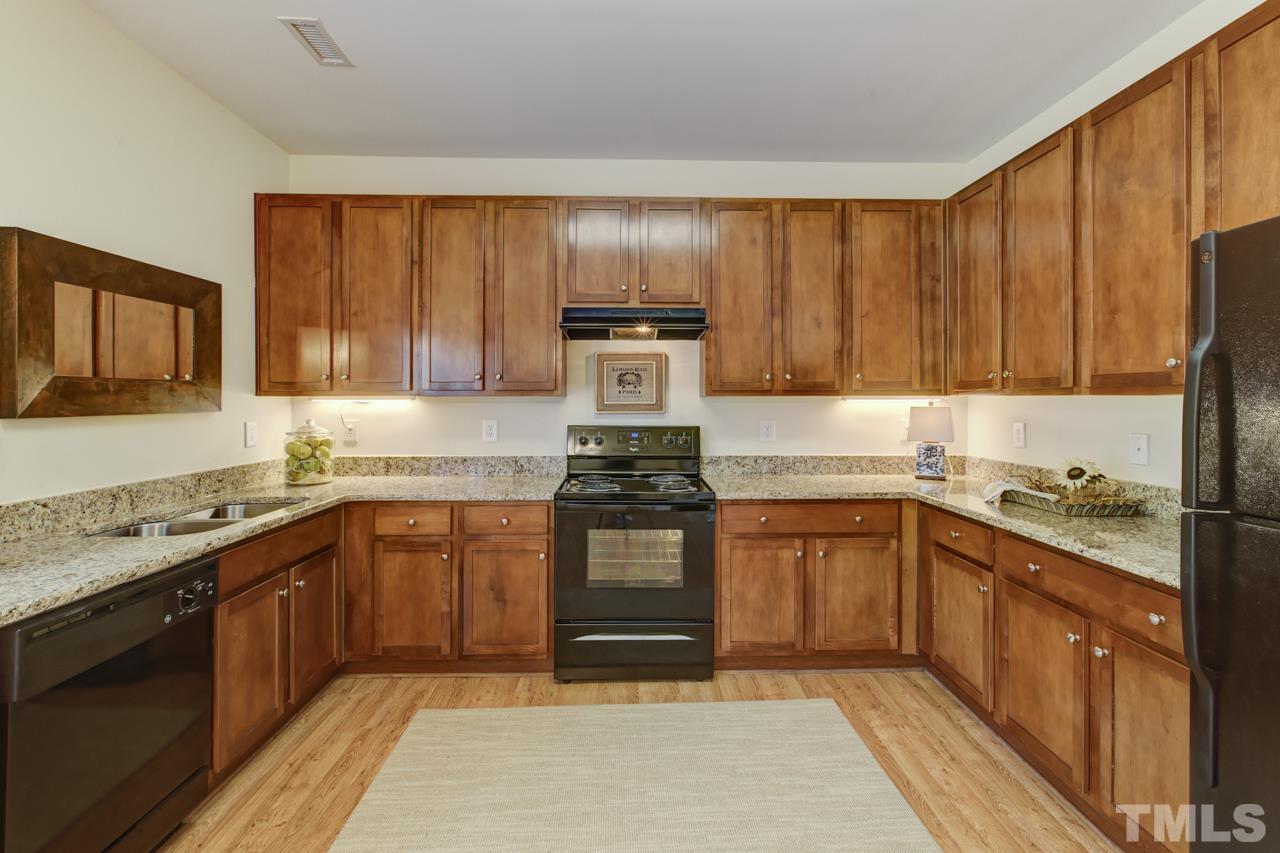 3620 Pinkham Way Raleigh, NC 27616 - Photo 2 of 25 a kitchen with stainless steel appliances granite countertop wooden cabinets stove top oven and sink