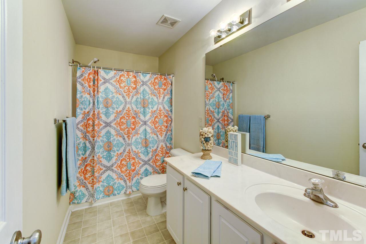 3620 Pinkham Way Raleigh, NC 27616 - Photo 18 of 25 a bathroom with a sink vanity mirror and toilet