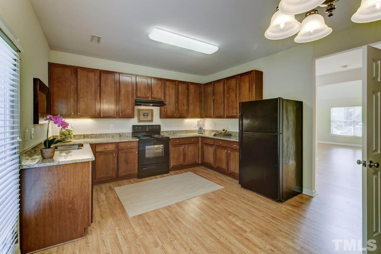 3620 Pinkham Way Raleigh, NC 27616 - Photo 3 of 25 a kitchen with a refrigerator sink and wooden cabinets