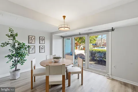 a dining room with furniture window and wooden floor