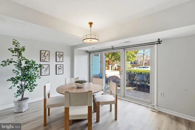 a dining room with furniture window and wooden floor