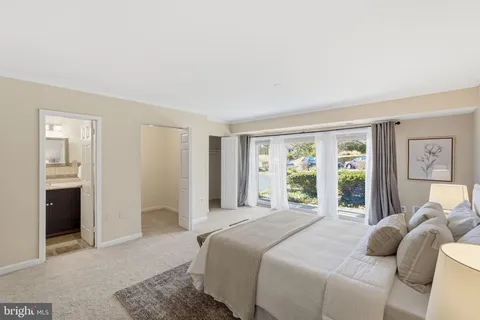 a bedroom with a bed and a large window