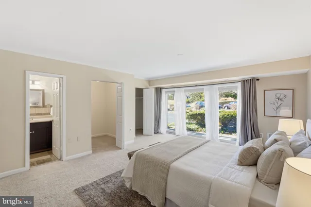 a bedroom with a bed and a large window