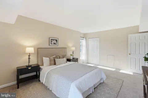 a bedroom with a bed and a lamp