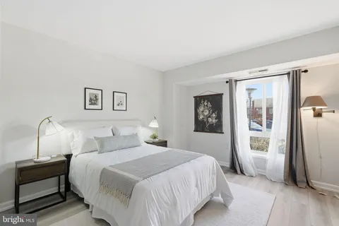 a bedroom with a large bed and a window