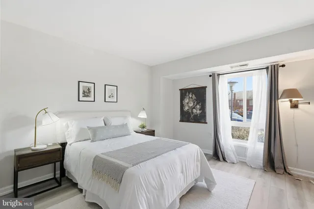 a bedroom with a large bed and a window